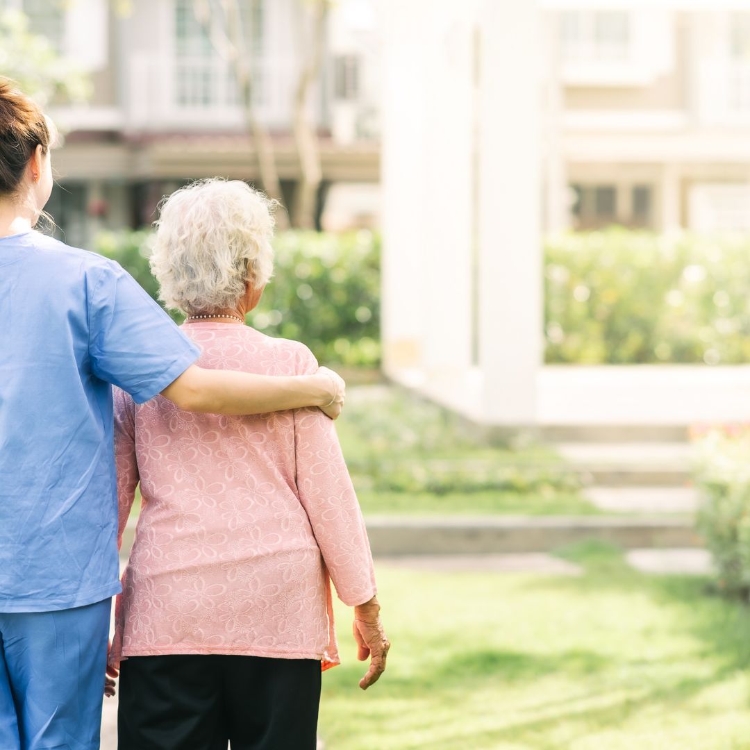 Nurse and senior walking together