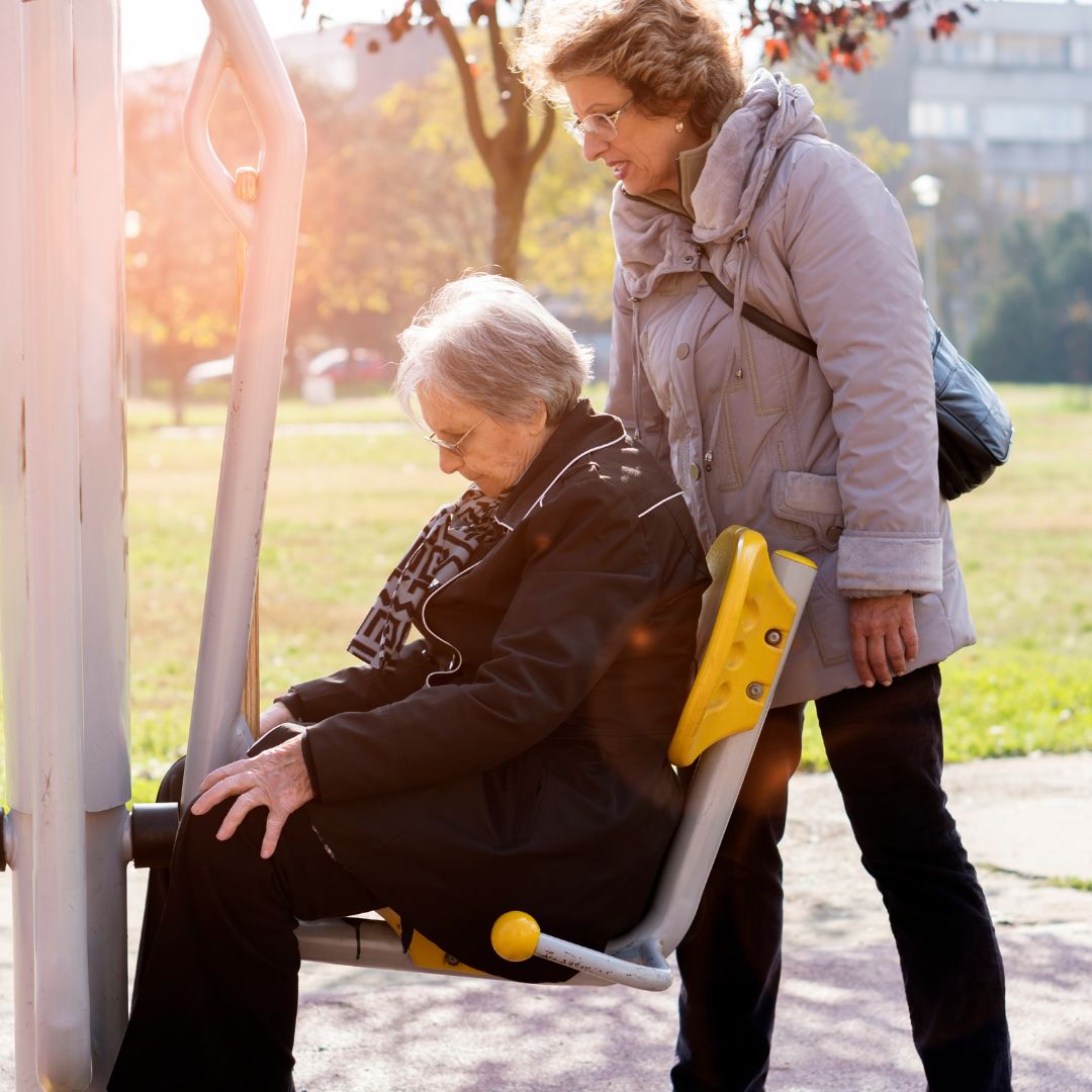 Woman pushing an elderly woman on a wheelchair
