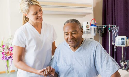 nurse_smiling_helping_patient_out_of_bed